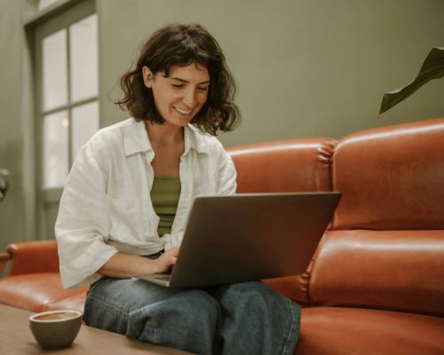 Happy Woman Doing Therapy Through a Laptop